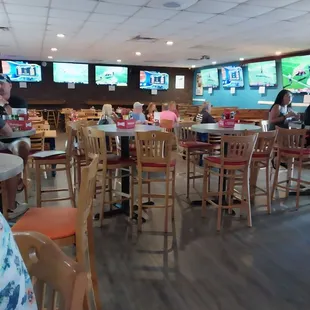 Inside dining area with many tvs