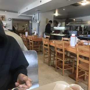 a man sitting at a table with a plate of food in front of him