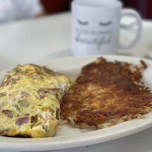 Meat over omelette With hashbrowns and I had sourdough bread on the side