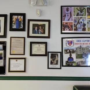 a wall full of framed photos