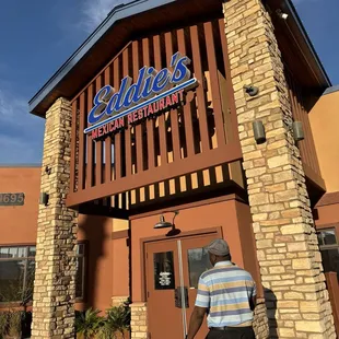 a man walking in front of the restaurant