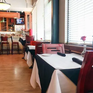 Set tables for parties of two by the window