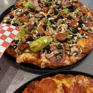Eddie &apos;s Famous Combination Pizza and pepperoni pizza