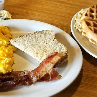 Bacon, scrambled eggs, wheat toast, and belgian waffle.