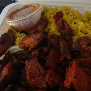 a plate of food with rice and meat