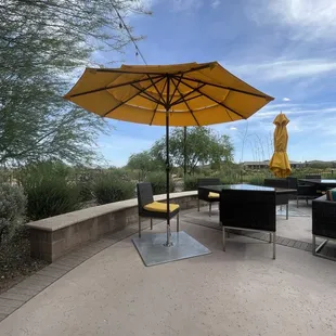 a patio with a table and umbrella