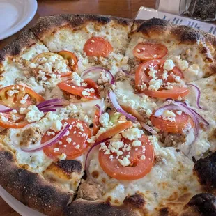 Pizza with chicken, tomato, onion, rosemary, gorgonzola, and lavender
