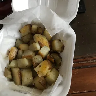 a container of fried potatoes