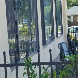 Ripped screen and broken window on patio