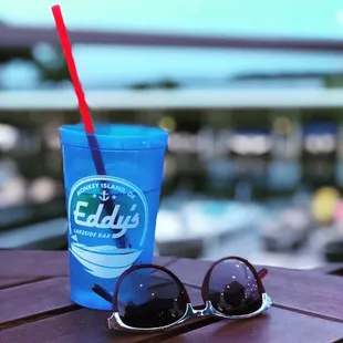 a blue drink and sunglasses