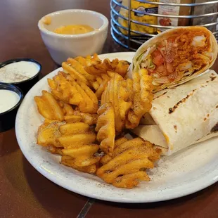 Buffalo chicken wrap rap with waffle fries,  a side of queso and extra ranch.