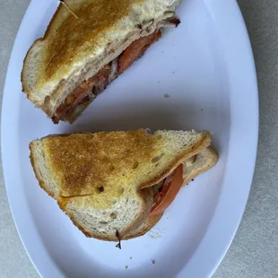 Hot Turkey, bacon, Swiss and tomato Sandwich grilled.
