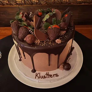 a chocolate covered cake with strawberries