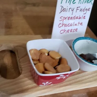 a bowl of crackers and a sign