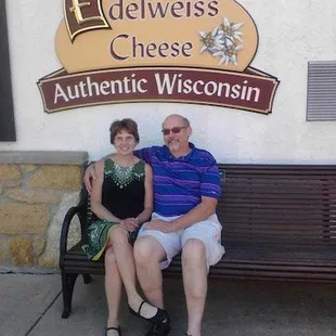 a man and woman sitting on a bench