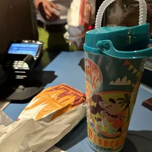 a plastic cup with a handle and a plastic straw
