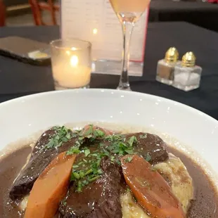 Steak &amp; Truffle mashed potatoes so tender and so delicious!! Background is the raspberry mimosa a must try!!