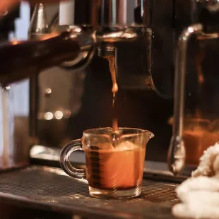 a person pouring a cup of coffee