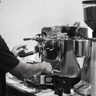 a woman making a cup of coffee