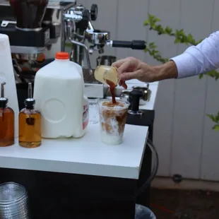 a man pouring coffee into a cup