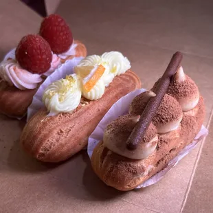 two hot dogs with whipped cream and raspberries