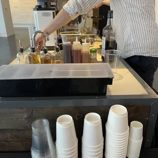 a person pouring coffee into cups