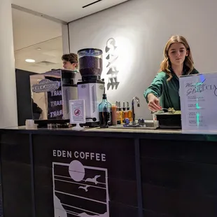 a woman standing behind a counter