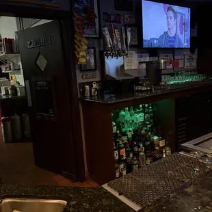 Inside sitting at the end of the bar.