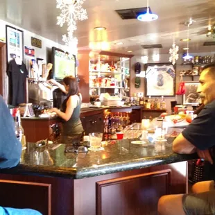 a group of people sitting at a bar