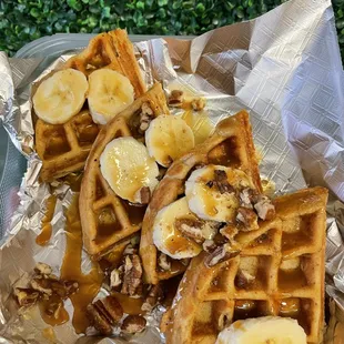 a plate of waffles and bananas