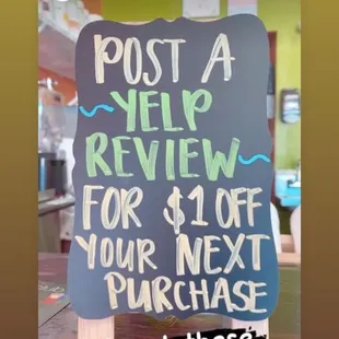 a sign that reads post a review for $ 10 off your next purchase