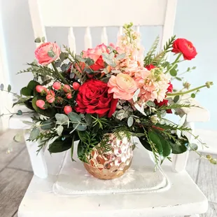 Casablanca. A chic arrangement of peach and magentas in a metallic container.