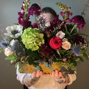 Anna. An organic, unstructured garden style arrangement in a rustic container.