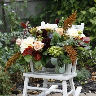 An exquisite, organic floral arrangement in an elegant compote.
