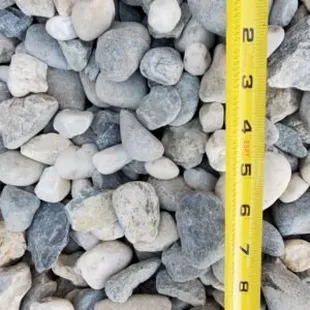 a measuring tape on a pile of rocks