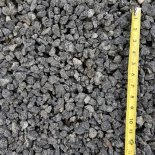 a measuring tape on a pile of gravel