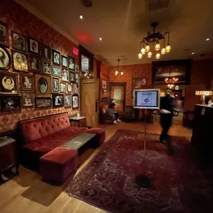 a living room with a red couch and a red rug