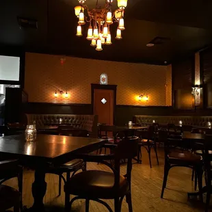 the interior of a restaurant with tables and chairs