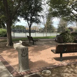 Water fountain, tennis courts and in-covered shaded benches