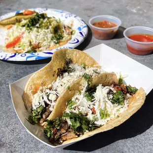 two tacoss on a plate