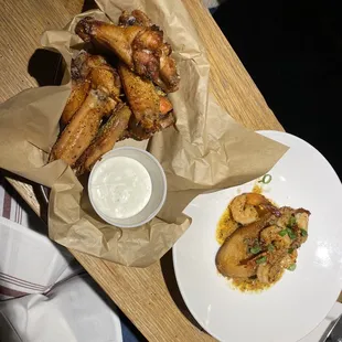 a plate of chicken wings and dipping sauce