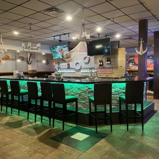 a bar with green lights