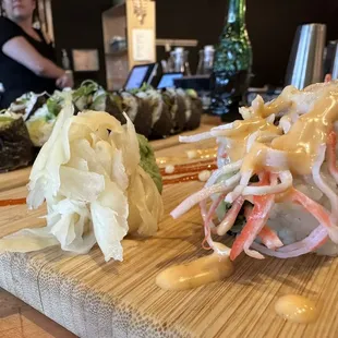 a variety of sushi on a cutting board