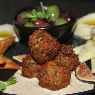 The Mezze Plate was made with pepper spread, hummus, tzatziki, baba ghanoush, falafel, olives, figs, and flatbread two ways.