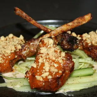 The Lamb Lollipops were made with harissa marinade, peanuts, tzatziki, and cucumber.