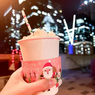 a hand holding a cup of ice cream