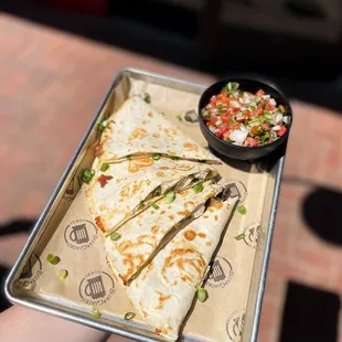 a hand holding a tray of food