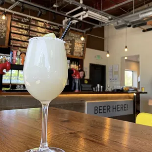 a glass of beer on a bar