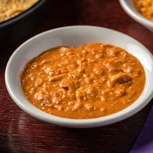 a bowl of chili and tortilla