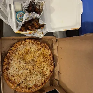 a pizza in a box and a box of chicken wings